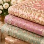 Stacked folded designer fabric sets with gold embroidery