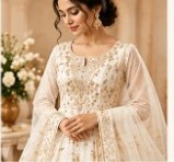 Cream ivory embroidered party wear outfit on a model