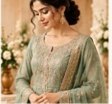 Sage green embroidered semi-stitched suit on a model